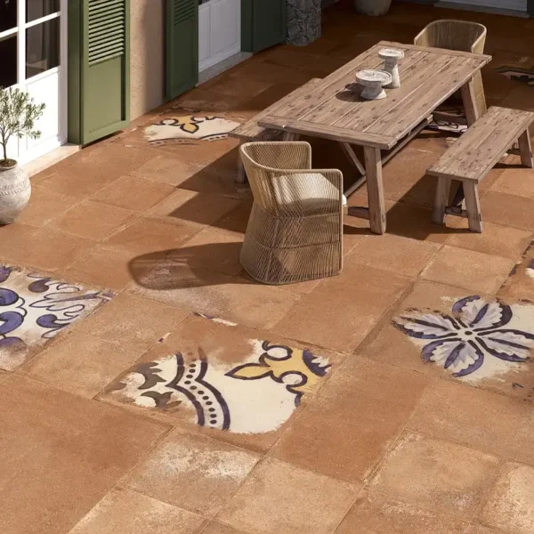 Terracota tile manufacturers catalogue´s picture showing a patio mixing terracotta tiles with aged big tiles 